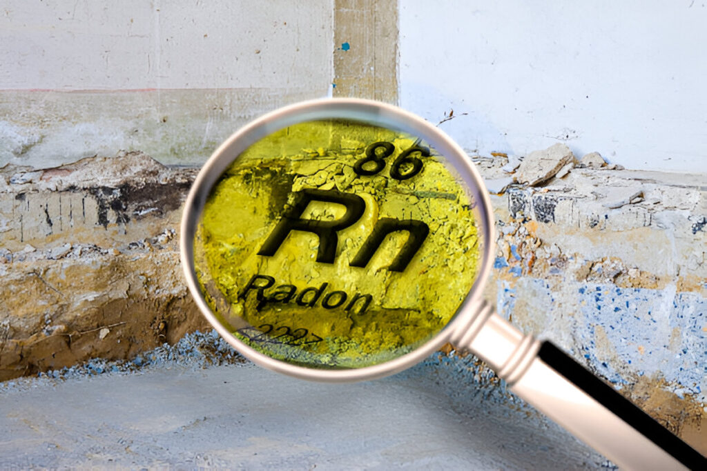 Magnifying glass revealing the atomic symbol for radon on a weathered wall background.